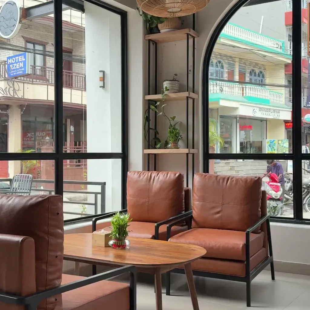 Leather chairs and arched windows inside Dear Breakfast