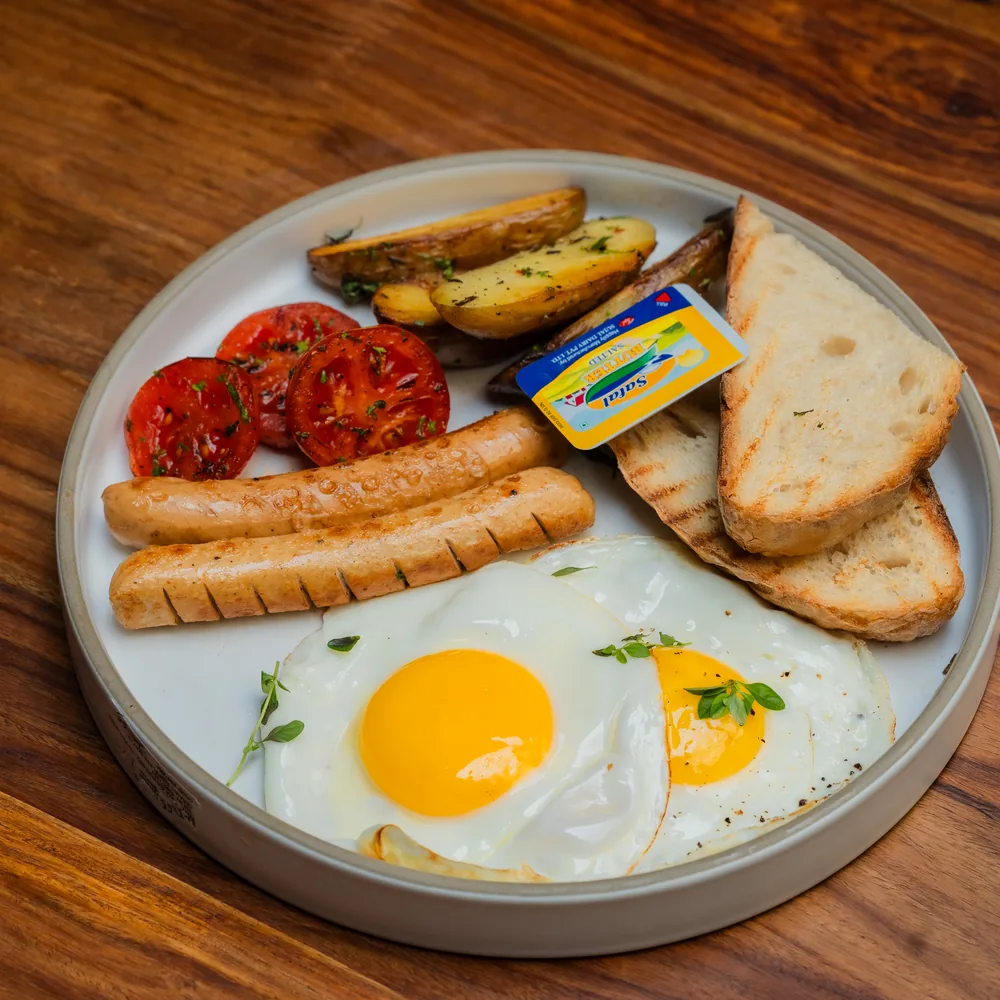Light and Healthy Breakfast plate with egg, toast, tomatoes and sourdough