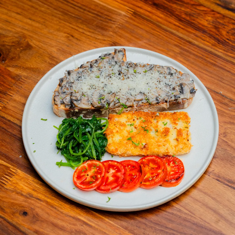 Mushroom Delight breakfast plate with toast, spinach, tomatoes and egg